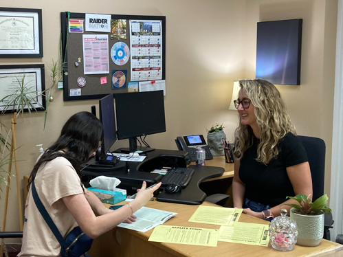 Counselor sitting with Student at the VR hosted Reality Town Event